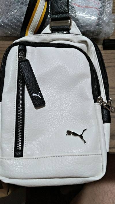 White messenger bag : Leathery texture, with great smooth touch. 3 compartment to personalize your stuff. easy carry on, on shoulder....