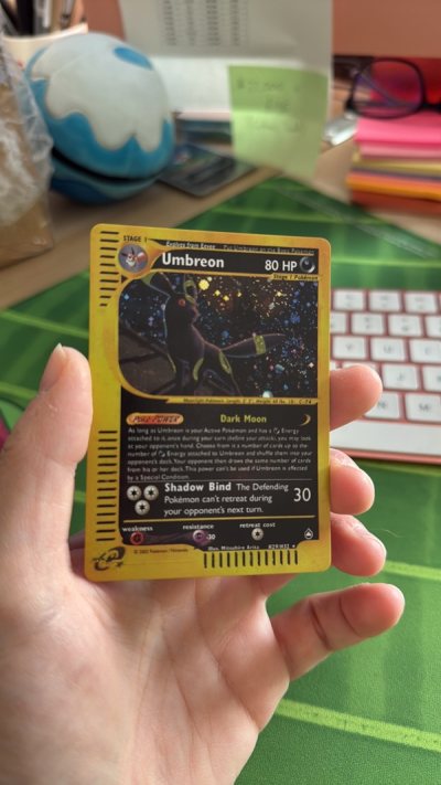 Upon inspection, the side of the card is solid white whereas Pokemon cards have a fine, black line along their edges because of the l...